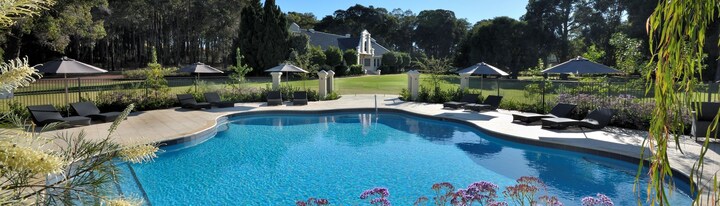 Lilly Pilly Cottage terrace with bistro table and chairs, timber door and landscaped path, Margaret River