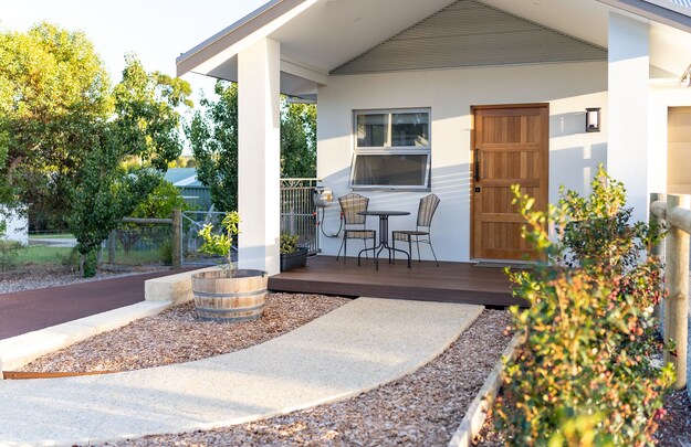 Lilly Pilly Cottage terrace with bistro table and chairs, timber door and landscaped path, Margaret River