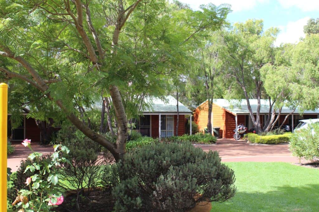 The expansive outdoor jarrah deck and lush garden at Home on Valley, a top-rated luxury choice for travelers deciding where to stay in Margaret River.