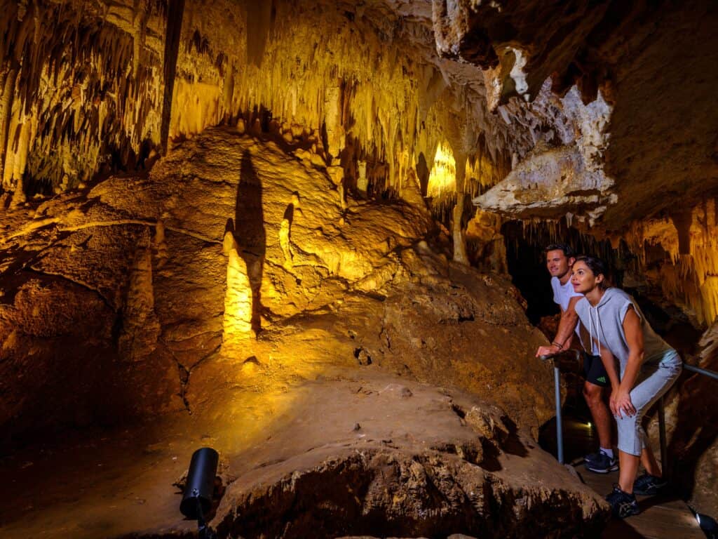 Visitors exploring Jewel Cave in Augusta, one of the best Margaret River caves to explore, surrounded by towering stalactites and limestone formations.
